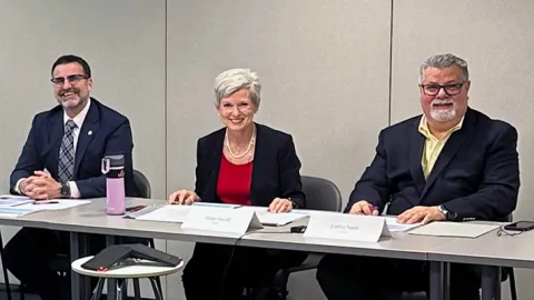 Bankruptcy Judge Laurel M. Isicoff (center) and a panel of financial legal experts.